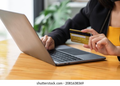 A Woman Holding A Laptop COMPUTER   And Credit Card For Shopping Online And Payment.Blank Screen Monitor For Graphic Display Montage