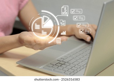  woman is holding a laptop with a glowing pie chart on the screen. The pie chart is divided into different sections, each representing a different aspect of the data being displayed - Powered by Shutterstock