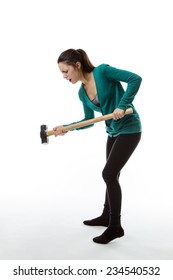 Woman Holding A Large Sledgehammer Smashing The Ground