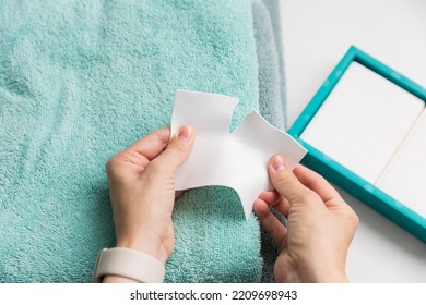 Woman holding a laudry sheet - Shutterstock ID 2209698943
