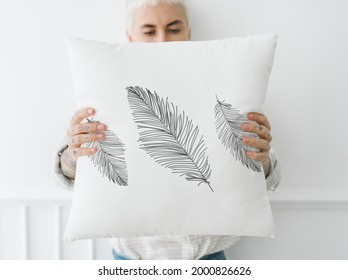 Woman  holding a leafy white pillow mockup