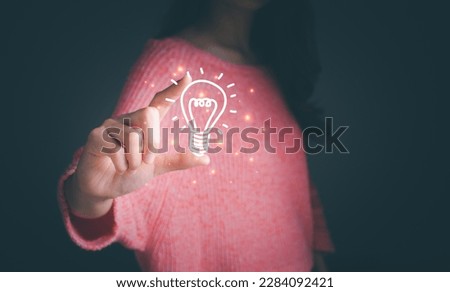 Woman holding light bulb icon. Concept of Ideas for presenting new ideas great inspiration online technology and innovation new beginning. Futuristic tone, neon color, Analyzing data, idea concept. 