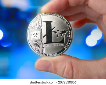 woman holding Litecoin, new virtual money