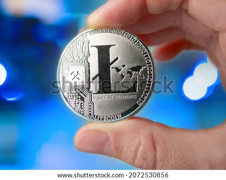 woman holding Litecoin, new virtual money