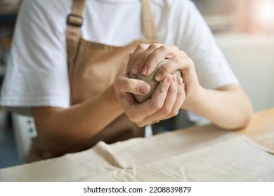 Woman Holding A Lump Of Clay In Her Hands