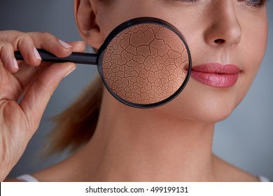 Woman Holding Magnifier And Zoom Damage On Skin