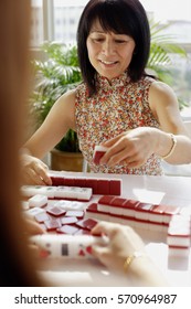 Woman Holding Mahjong Tile