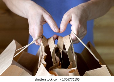 Woman Holding Many Brown Carton Paper Bags. Lots Of Purchases After Shopping. Consumerism Concept.