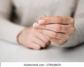 Woman Holding Marriage Ring. Divorce.