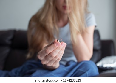 Woman Holding A Marriage Ring. Marriage Problems. 