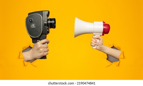 Woman holding megaphone and small video old retro black camera 8 mm in paper torn hole in yellow background