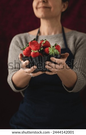 Similar – Woman holds strawberries in her hands