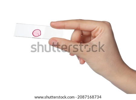 Woman holding microscope slide with sample on white background, closeup