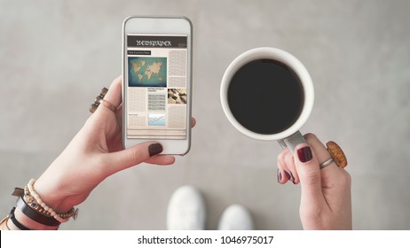 Woman Holding Mobile Phone And Reading News From Screen Other Hand Holding Coffee Cup