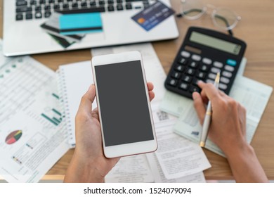 Woman holding mobile phone and using calcutor, account and saving concept