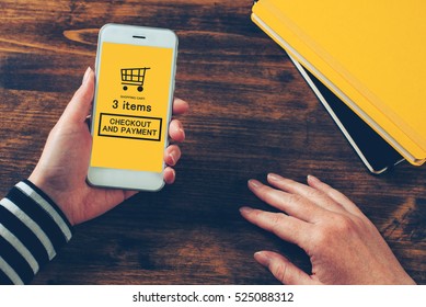 Woman Holding Modern Mobile Phone With Online Shopping App, Ready To Checkout And Make Electronic Payment On Internet.