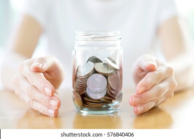 Woman Holding Money Jar With Coins Close Up