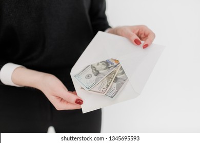 Woman holding money and using smartphone. Currency payment concept. American dollar bills.