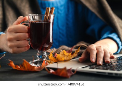 Woman holding mug of hot drink (apple tea, mulled wine). Female hands with cup of seasonal hot drink. Homemade hot fruit tea.