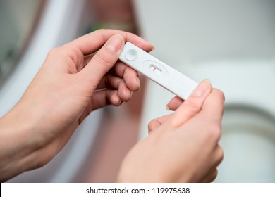 woman holding negative pregnancy test