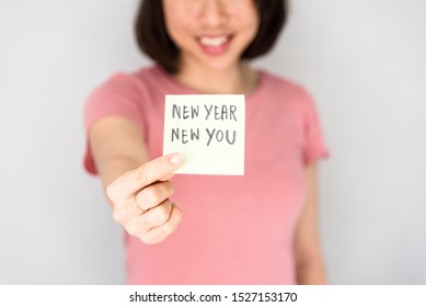 Woman Holding A New Year New You Card, New Year Resolution Concept.