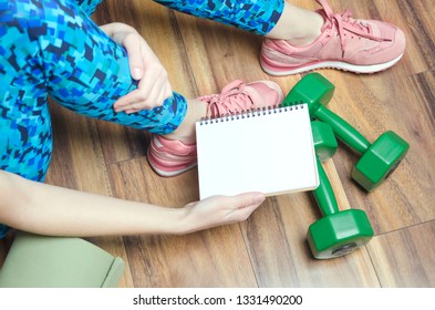 Woman Holding Notebook With Schedule Of Her Personal Practice.Active Lifestyle Everyday