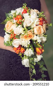 Woman Holding On To A Beautiful Cascade Flower Bouquet 