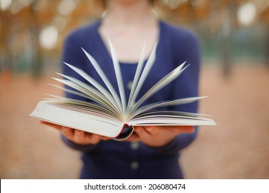 Woman Holding Open Book