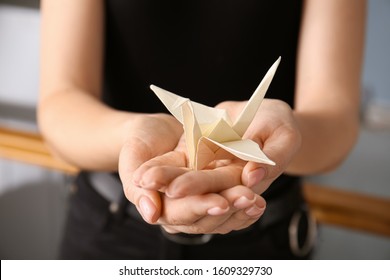 Woman Holding Origami Crane, Closeup