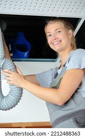 Woman Holding Overhead Ventilation Hose