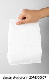 Woman Holding Paper Bag On White Background, Closeup