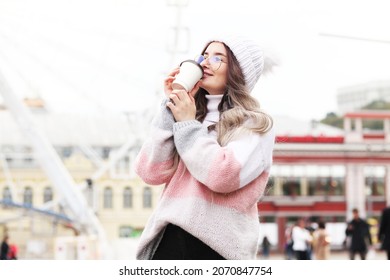 Woman Holding Paper Cup And Drinking Coffee During Waiting The Train At The Station. Wintertime