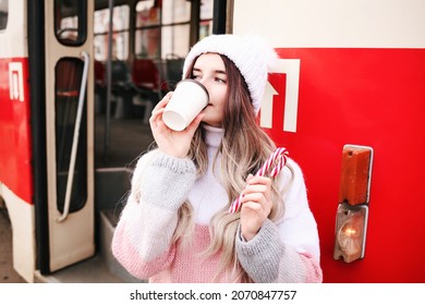 Woman Holding Paper Cup And Drinking Coffee During Waiting The Train At The Station. Wintertime