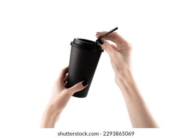 Woman holding paper cup of hot coffee with white background. Female hand with black nails. High quality photo