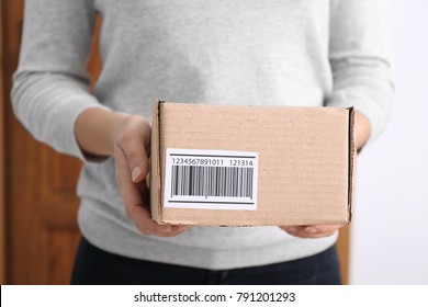 Woman Holding Parcel Box Near Door, Closeup