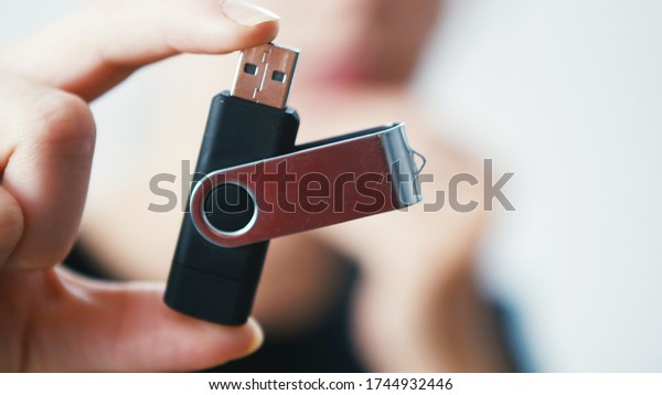 Woman\
holding a Pen Drive Flash USB Computer Memory\
Stick
