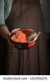 Woman Holding A Pet Bowl With Raw Trout In Hand. Rustic Style. Vertical.