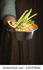 Woman Holding A Pet Bowl With Vegan Food In Hand. Rustic Style. Vertical.