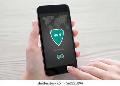 woman holding phone with app vpn creation Internet protocols for protection private network