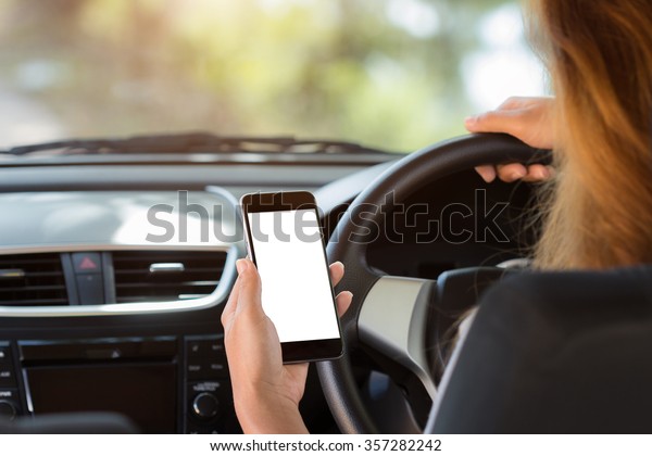 woman\
holding phone in car clipping path white\
screen