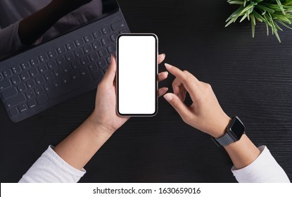 a woman holding phone showing white screen on top view