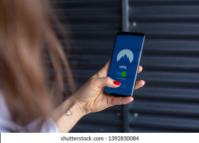 Woman Holding Phone With Vpn App