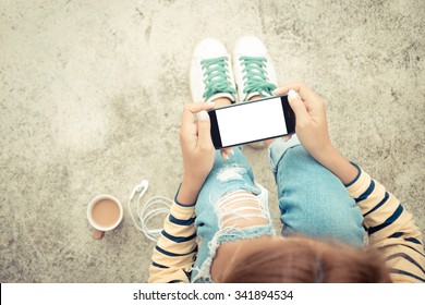 woman holding phone white screen on top view vintage style
