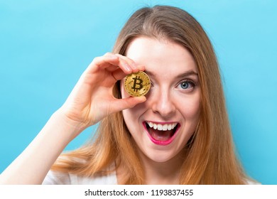Woman holding a physical bitcoin cryptocurrency in her hand
