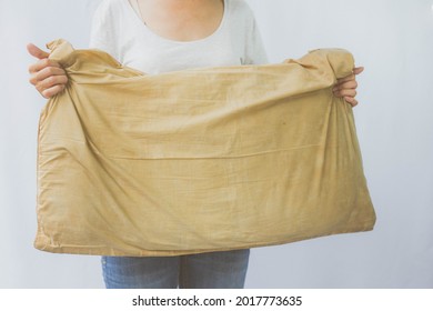 Woman Holding A Pillow With Dirty Stains, Yellow Stains, Sweat Stains. Cleaning Concept.