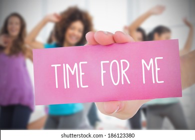 Woman Holding Pink Card Saying Time For Me Against Class In Gym