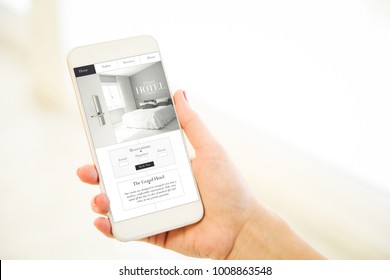 Woman Holding A Pink Gold Generic Smartphone Showing Grand Hotel Website