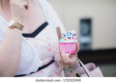 Woman Holding Pink Ice Cream Tub