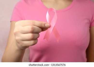 Woman holding pink ribbon, closeup. Breast cancer awareness - Shutterstock ID 1313567576