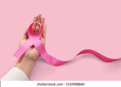 Woman holding pink ribbon on pink background copy space./Health care and cancer female concept. - Shutterstock ID 1510988840